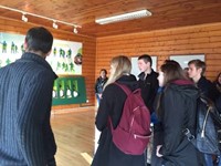 students looking at demonstration board