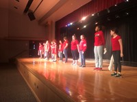 students lined up on stage