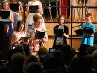 four students singing 