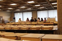 wide far shot of students learning about book records