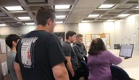 woman showing students how to search online records