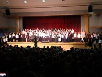 wide shot of middle school and high school choirs combined