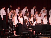 medium shot of more students singing