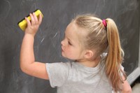 student erasing chalkboard