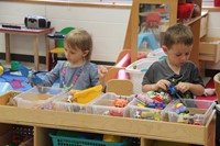 students holding toys