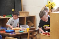 students playing in toy kitchen