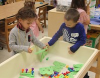 students playing with letter blocks
