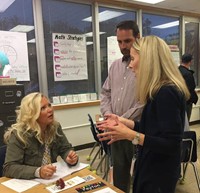 adults and teacher speaking in classroom