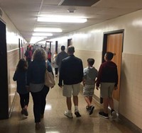 people walking in hallway