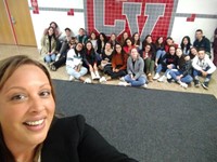 principal ostrander taking selfie with french students