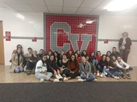 students in front of c v mural