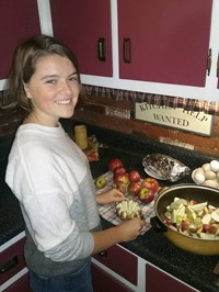 Chenango Valley French Exchange student cutting apples