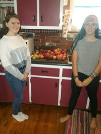Chenango Valley French Exchange students standing next to apples