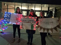 three Chenango Valley students holding welcome signs