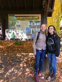 students standing next to sign for bald mountain fire tower