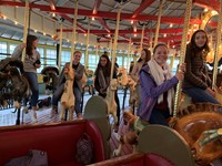 students riding carousel