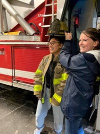 students trying on fire gear