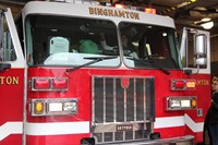 wide shot of student in fire truck pulling horn