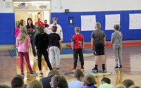 medium shot of students playing activity based on being present