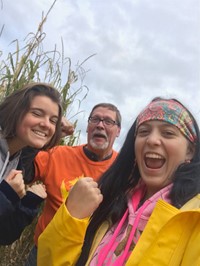 students and adult at corn maze