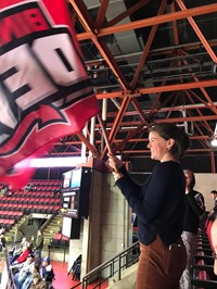 student holding binghamton devils hockey flag