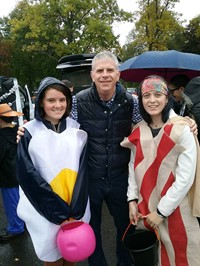 students dressed in costumes standing next to county executive