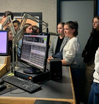 students talking to radio station host