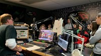 students talking to radio host in studio
