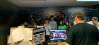 students talking in radio station studio