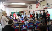 french students talking to elementary class