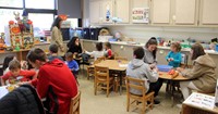 wide shot of french students and pre k students taking part in activities