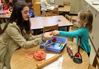 french student and pre k student playing with play doh