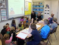 french students talking to elementary class