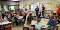 french students talking to elementary class