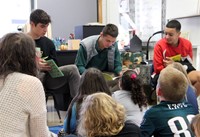 french students reading to elementary class