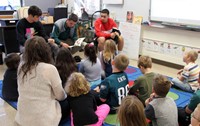 french students reading to elementary class