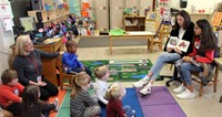 french students reading to elementary class