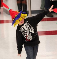 student pretending to be scarecrow at pre k halloween parade