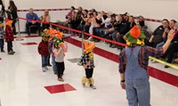 students waving to guests at pre k halloween parade