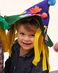 student smiling wearing scarecrow hat