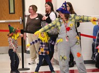 students and teacher in pre k halloween parade