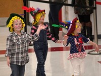 three students at pre k halloween parade