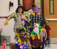 students and teacher in pre k halloween parade