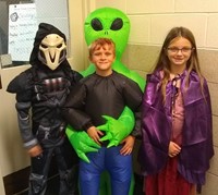 three students in costumes