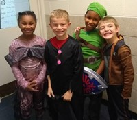 four students in costumes