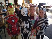 four students in costumes