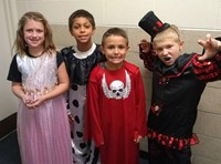 four students in costumes