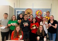 high school students holding marshmallow skulls for dia de los muertos