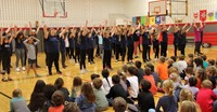 Port Dickinson elementary students clapping for middle school students