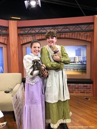 cast members holding puppies